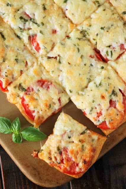 Fresh tomatoes and basil slathered with melty cheese, and layered on a crescent roll crust ~ the perfect versatile savory little treat. Enjoy Crescent Roll Tomato-Basil Squares for a party, lunch, brunch, or even as a tasty afternoon snack.